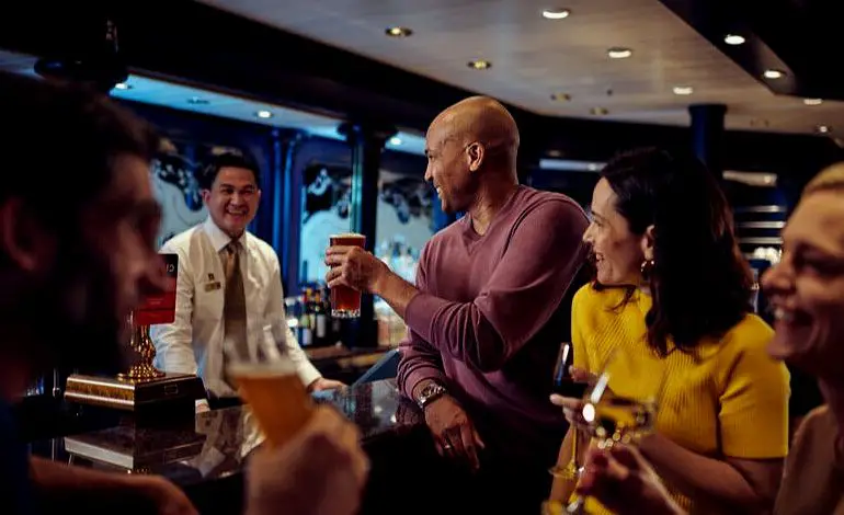Cunard guests drinking at Golden Lion Pub