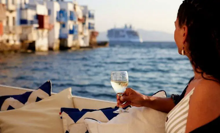 Silversea guest drinking white wine in Mykonos